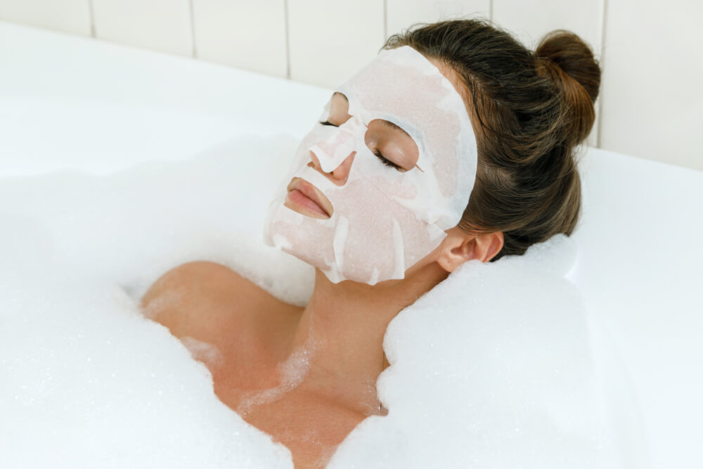 Woman in bath with face mask