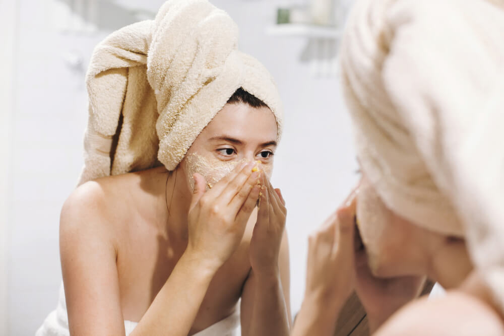 Woman using face scrub