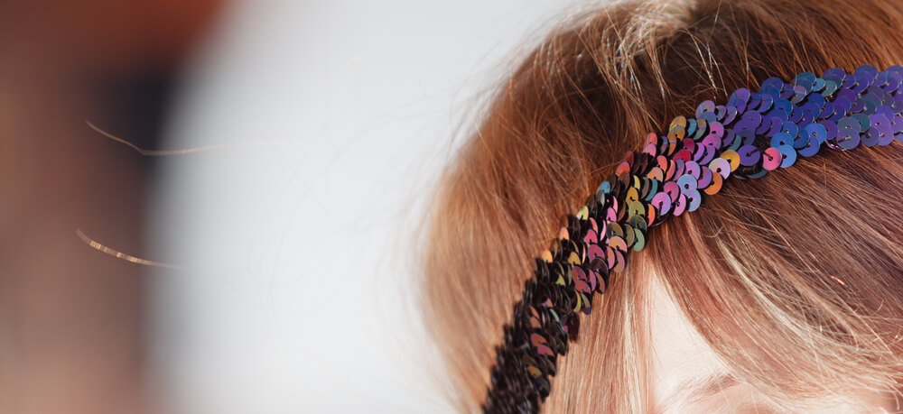 Close-up of sequin headband on head