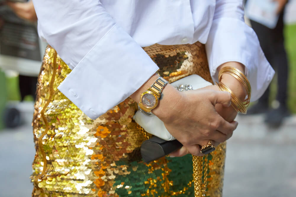 Close-up of woman wearing sequin skirt holding bag