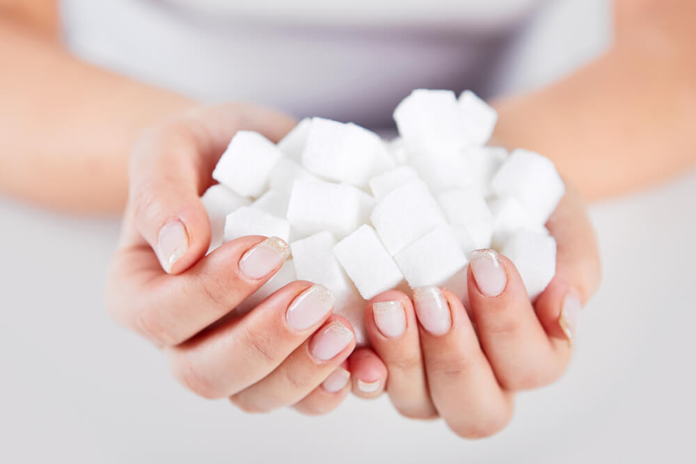 Hand holding sugar cubes