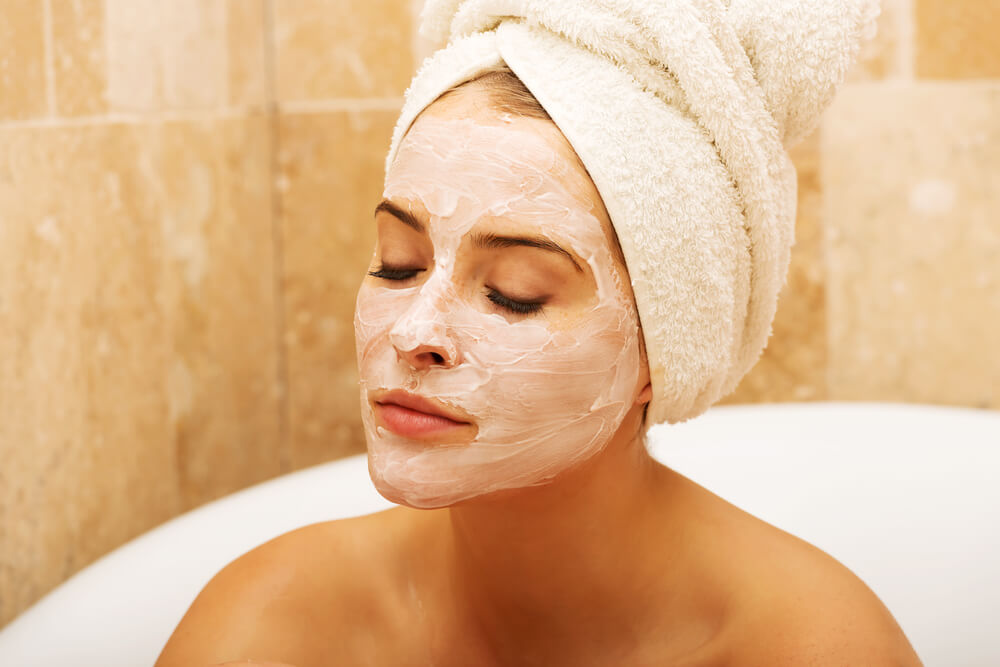 Woman in bath with face mask