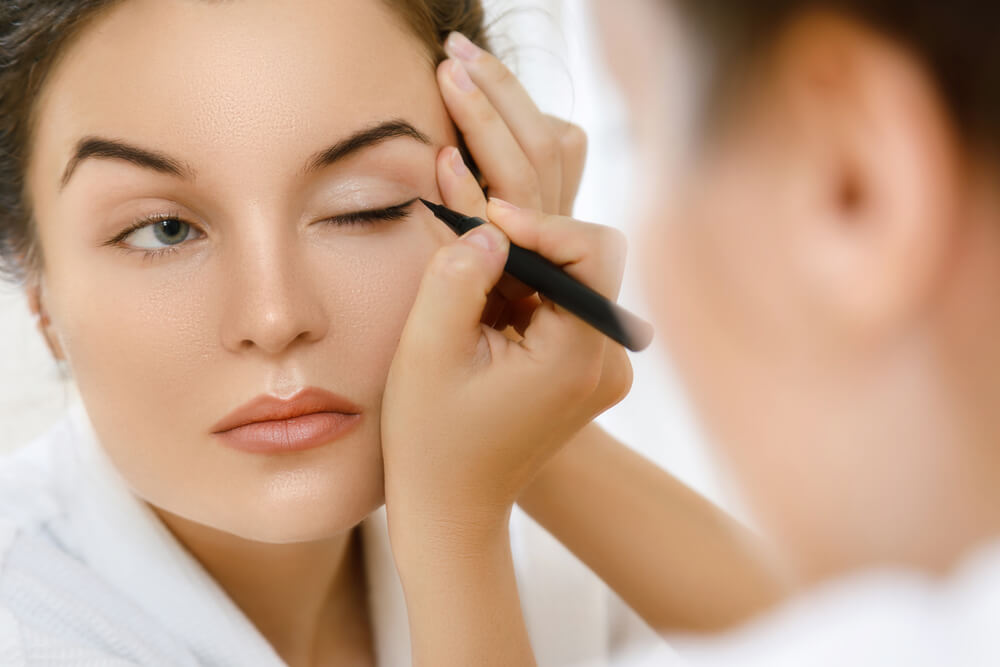 Woman applying eyeliner