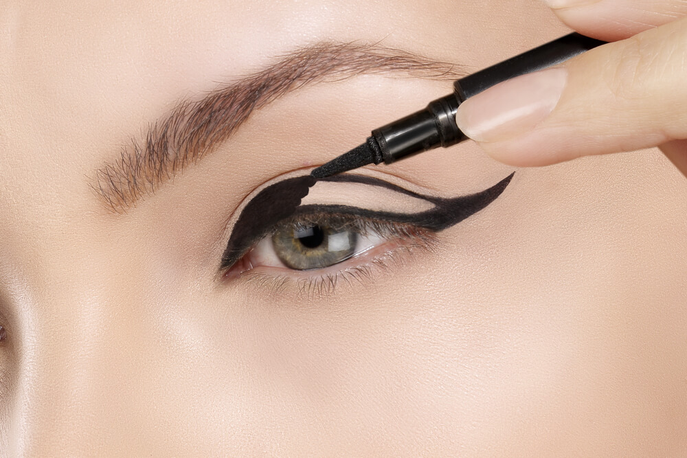 Woman applying eyeliner