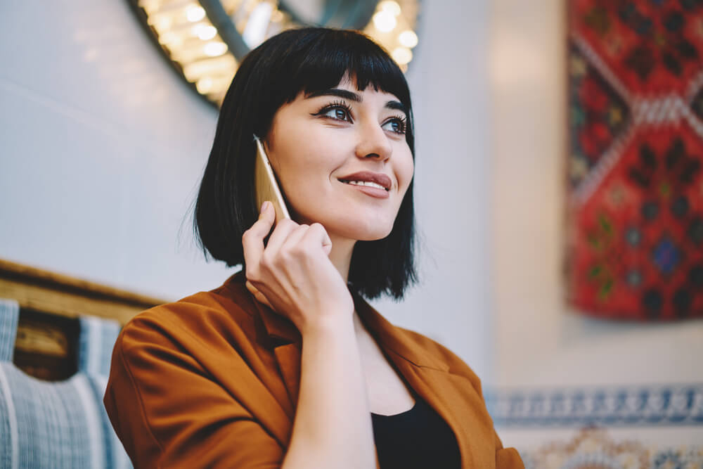 Woman on phone with short bangs