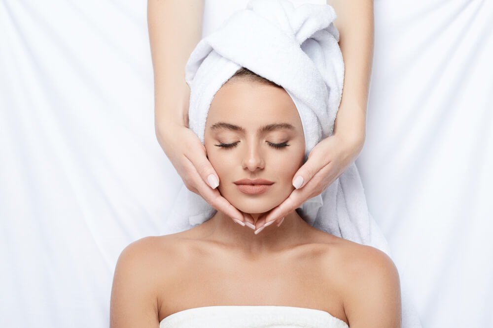 Woman having head massage in spa