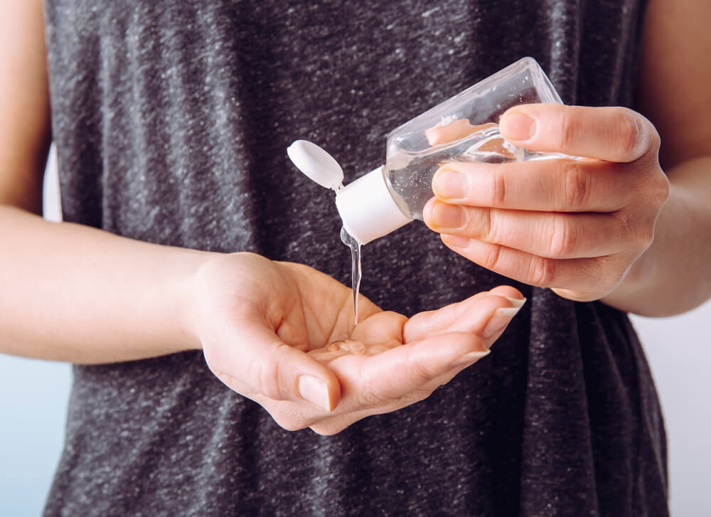 Woman using hand sanitizer