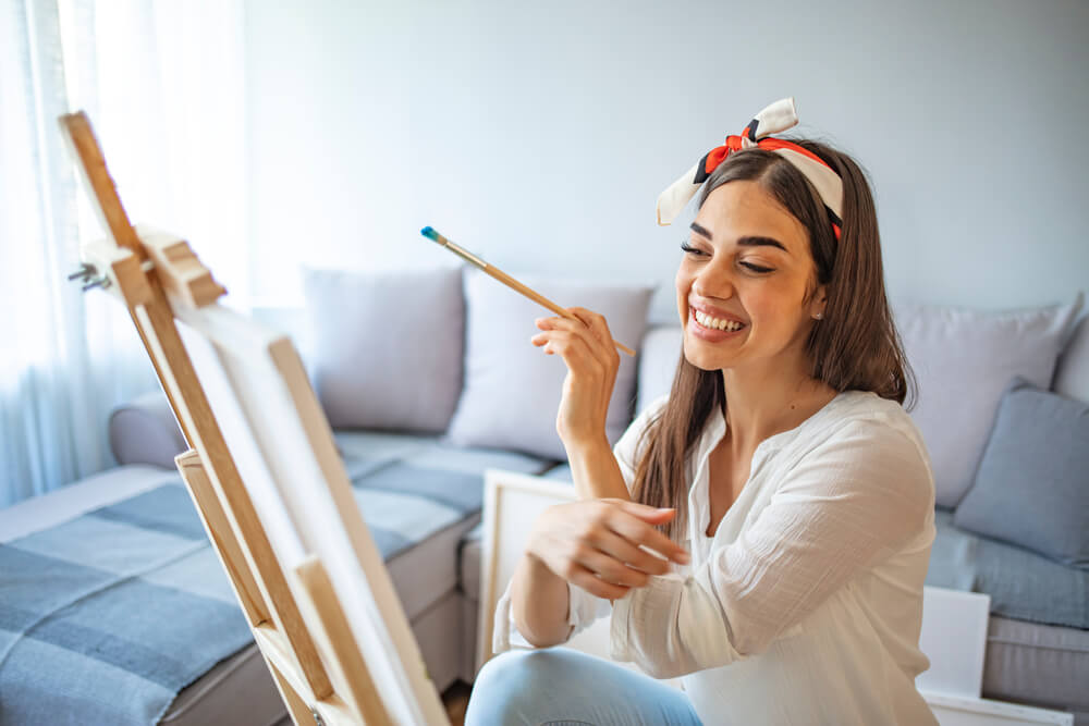 Woman painting on canvas