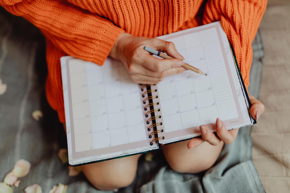 Woman writing in day planner