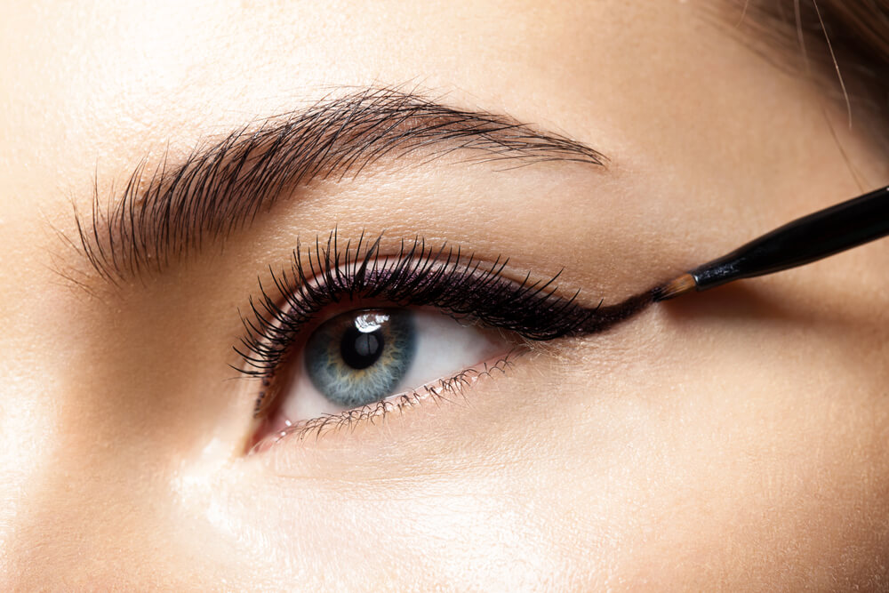 Woman applying eyeliner