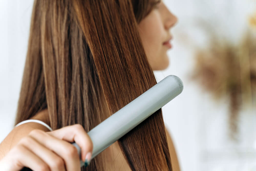 girl straightening hair