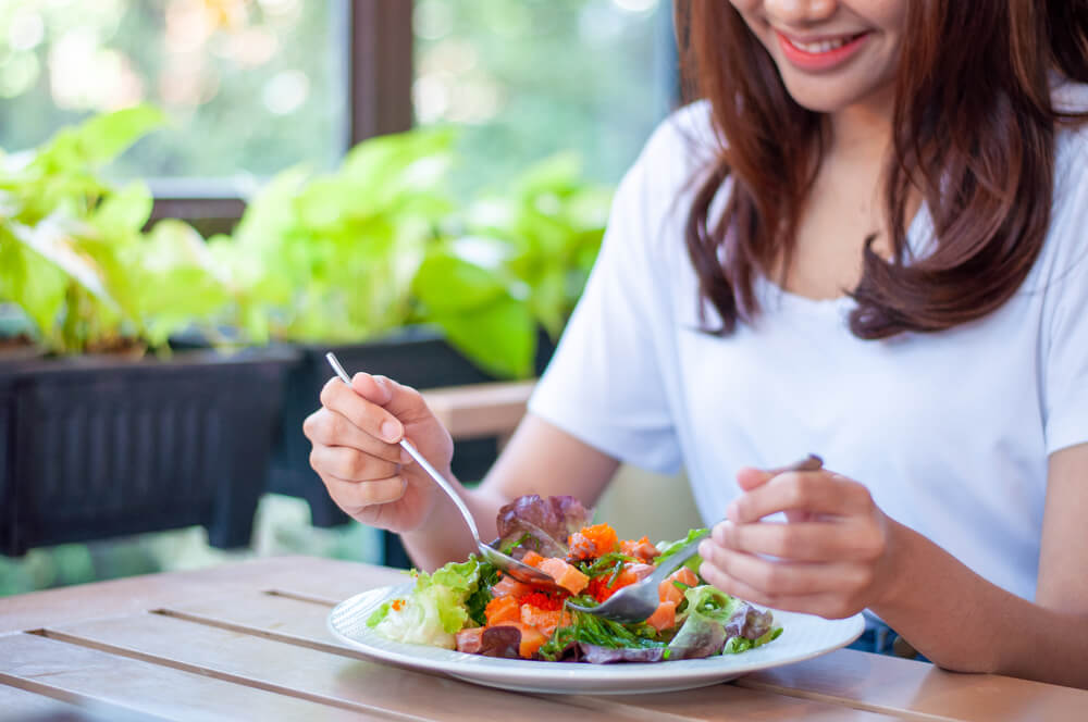 woman eating salad