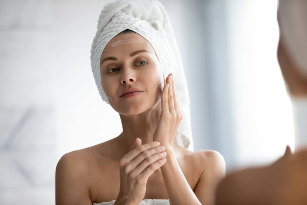 woman looking at skin