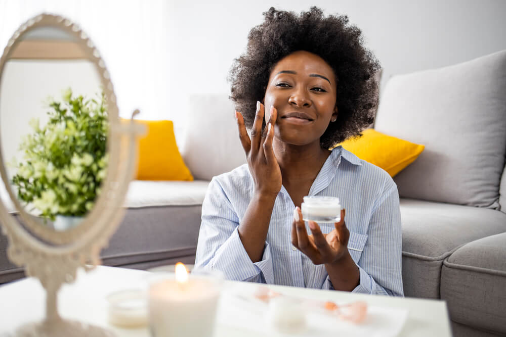  woman applying moisturizer