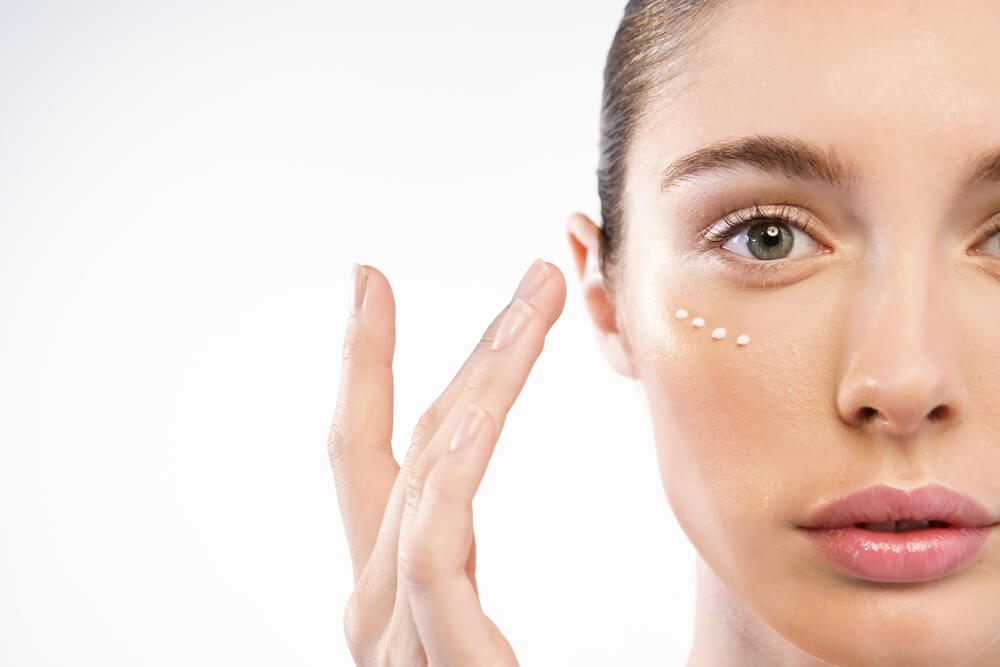 woman applying eye cream