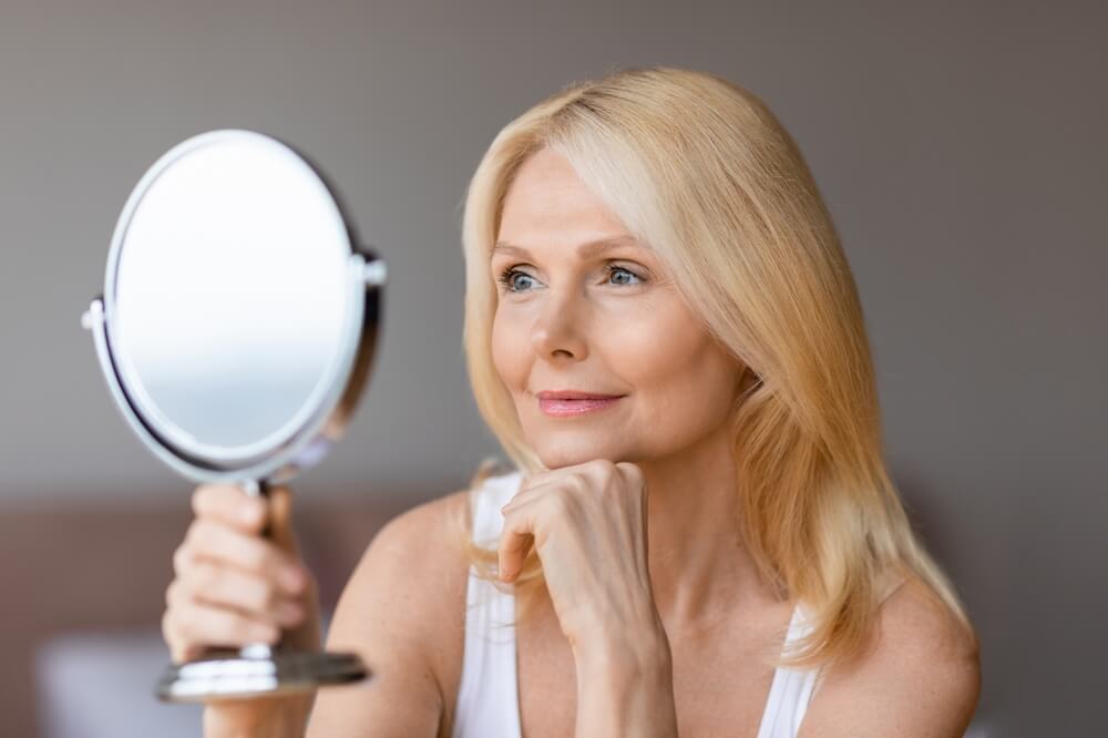 woman holding mirror