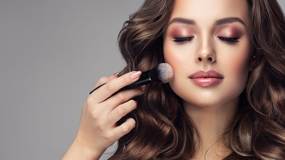 woman applying makeup