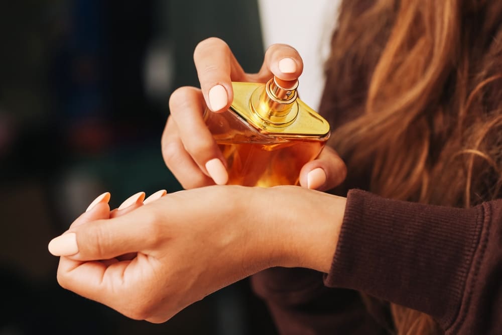 Woman applying perfume