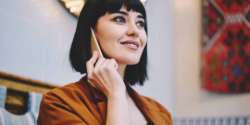 Woman on phone with short bangs