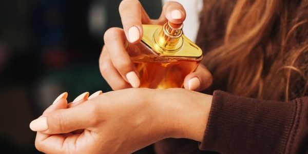 Woman applying perfume