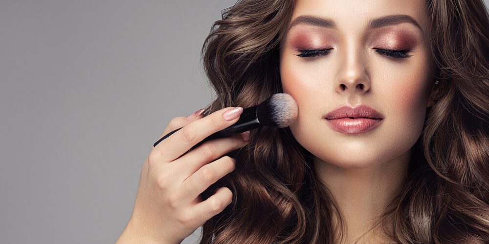 woman applying makeup