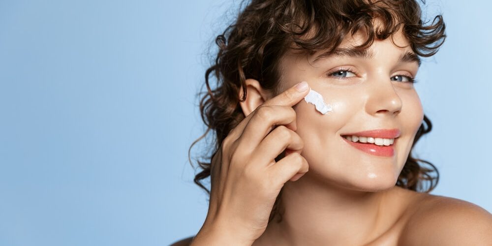 woman applying moisturizer